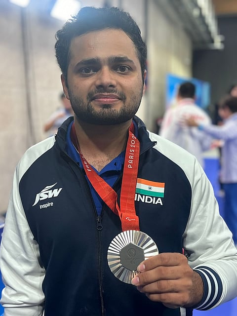 Manish Narwal poses with the silver medal.